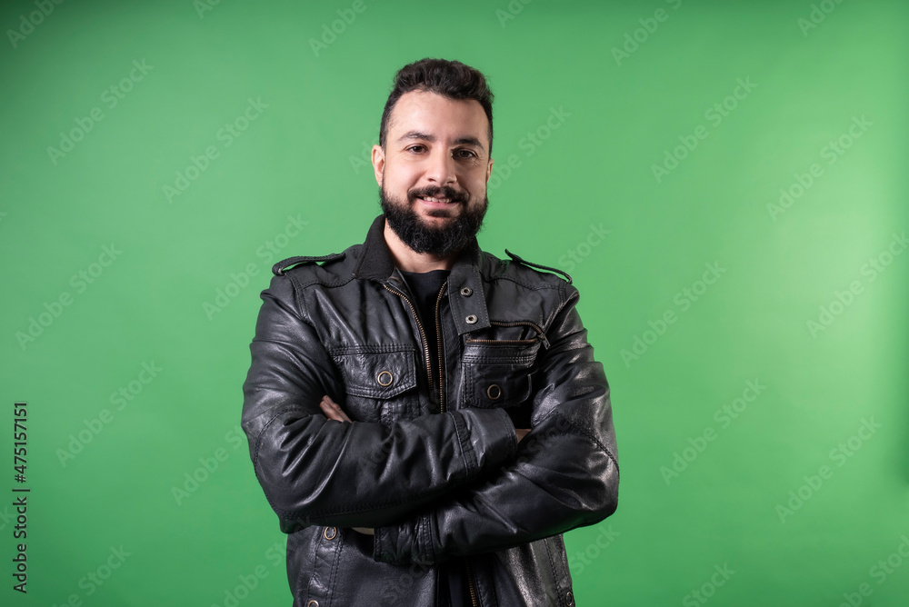 bearded man in leather jacket looks at camera smiling bearded man in leather jacket looks at camera smiling