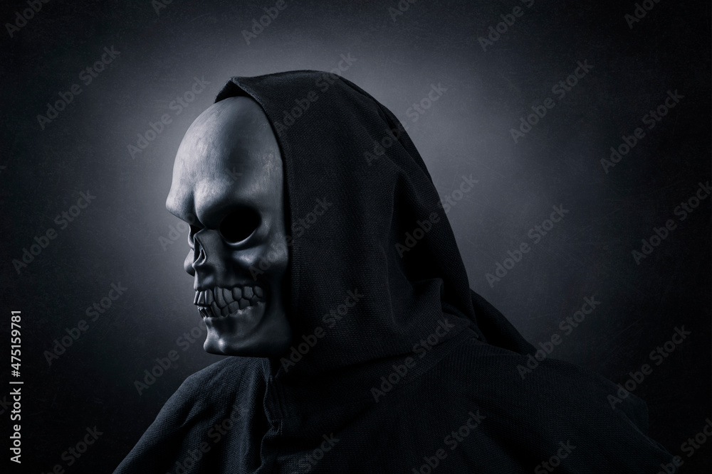 Grim reaper over dark misty background Grim reaper over dark misty background