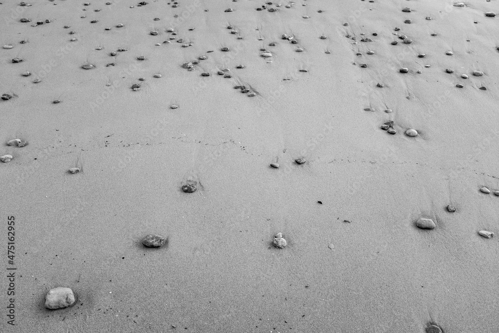 Background of sand sea beach with stones, closeup. Beautiful sand beach for poster, calendar, post, screensaver, wallpaper, postcard, card, banner, cover, header for website. Brown tones colors Background of sand sea beach with stones, closeup. Beautiful sand beach for poster, calendar, post, screensaver, wallpaper, postcard, card, banner, cover, header for website. Brown tones colors