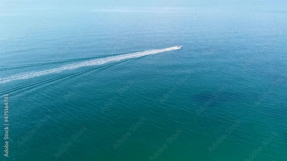 Aerial view of a boat alone in the blue sea in Sardinia, Italy Aerial view of a boat alone in the blue sea in Sardinia, Italy