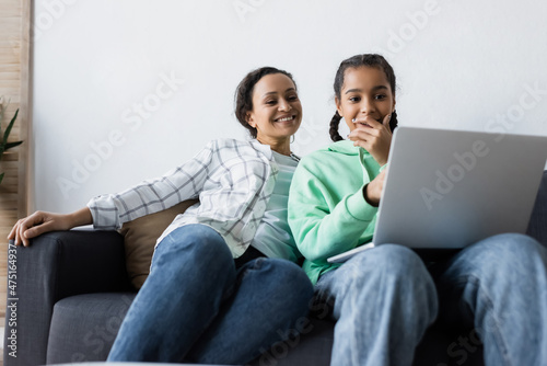 amazed african american teenage girl covering mouth with hand while watching mov Fototapet