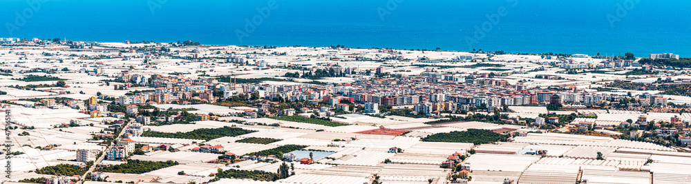 Panoramic view of many greenhouses stretching across the resort and agricultural city of Demre in Turkey. Farming and business production of cucumbers, tomatoes and other vegetables