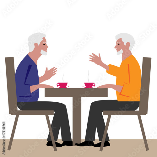 Two elderly men sit at a table and drink tea.