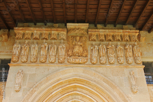 Detail of the late Gothic frieze with Jesus Christ and the apostles on the archivolts of the southern entrance door to the Romanesque church of Pisón de Castrejón, Palencia, Spain