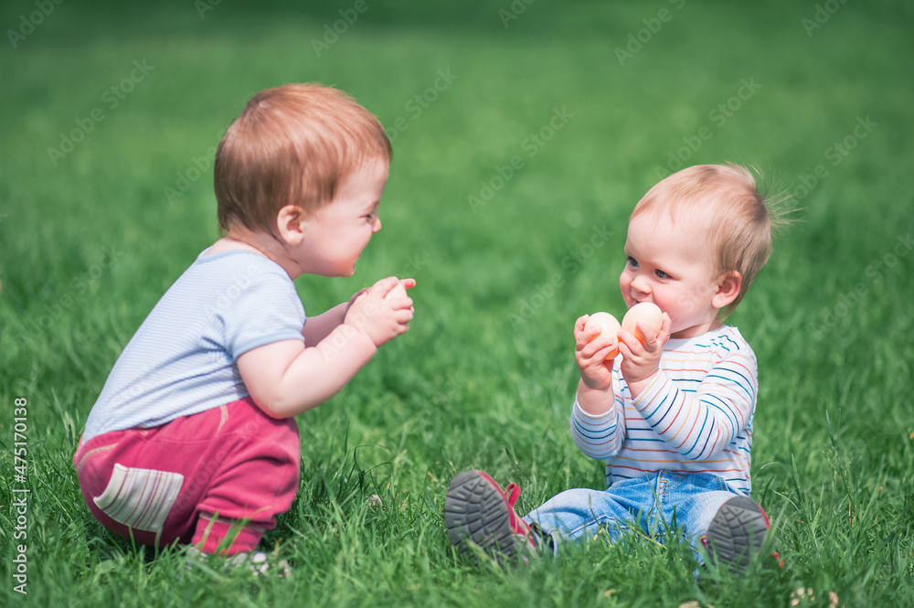 Toddler eggs hunters close-up. Children activity for Easter in nature.. Toddler eggs hunters close-up. Children activity for Easter in nature..