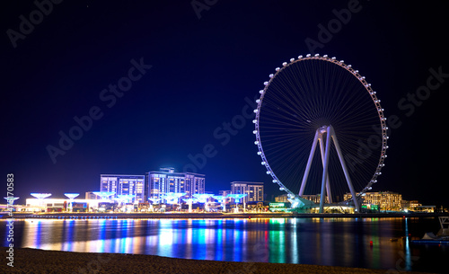 Ferris wheel against the blue sky in Dubai