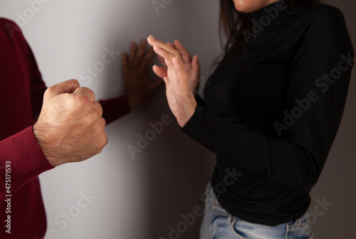 Closeup of aggressive man hand grabbed woman hand