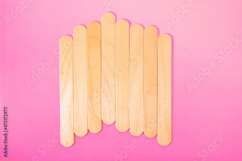 wooden spatulas for hot wax depilation. beauty industry background. body care