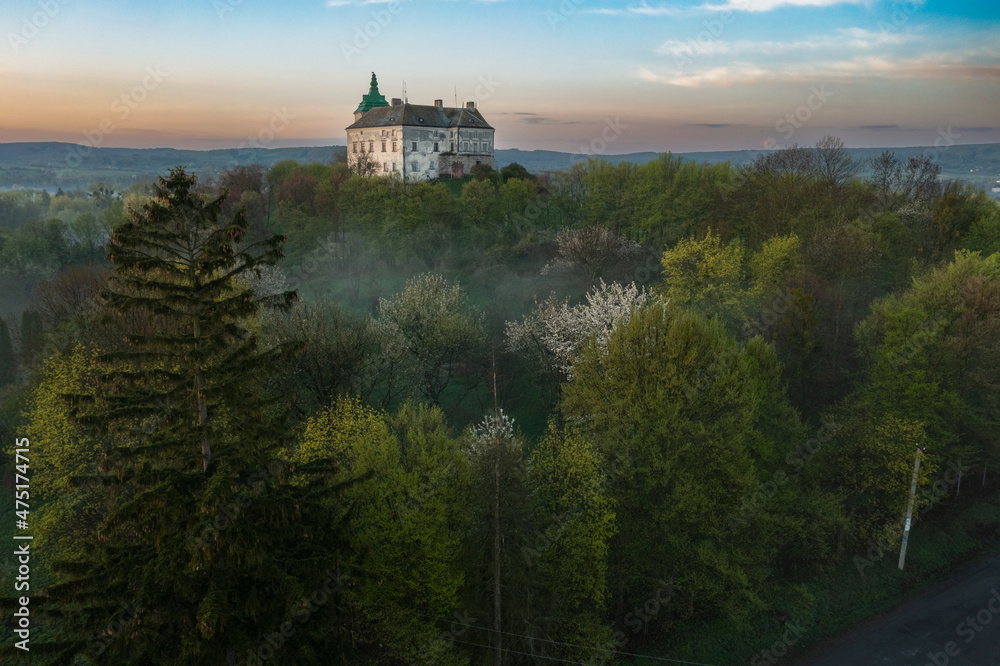 Aerial view of the Olesko castle. A very beautiful castle in foggy dark weather. Lviv region, Ukraine. Tourism, travel.