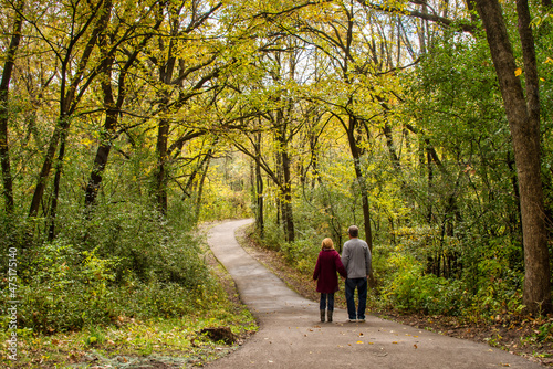 couple walking in park with autumn fall colors 
