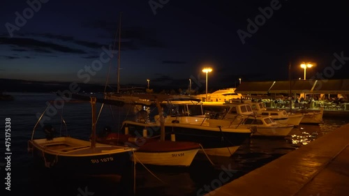 SUPETAR, DALMATIA, CROATIA - AUGUST 30, 2021: Boats in the evening in Supetar in Croatia. Handheld, 4K photo