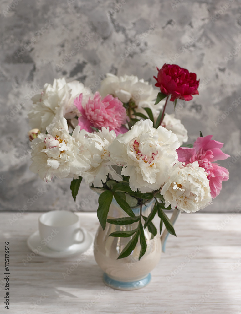 Fototapeta premium Still life with white and pink peonies in a white vase