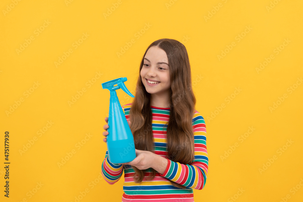 Happy kid hold disinfectant spraying bottle for copy space yellow background, spray Happy kid hold disinfectant spraying bottle for copy space yellow background, spray
