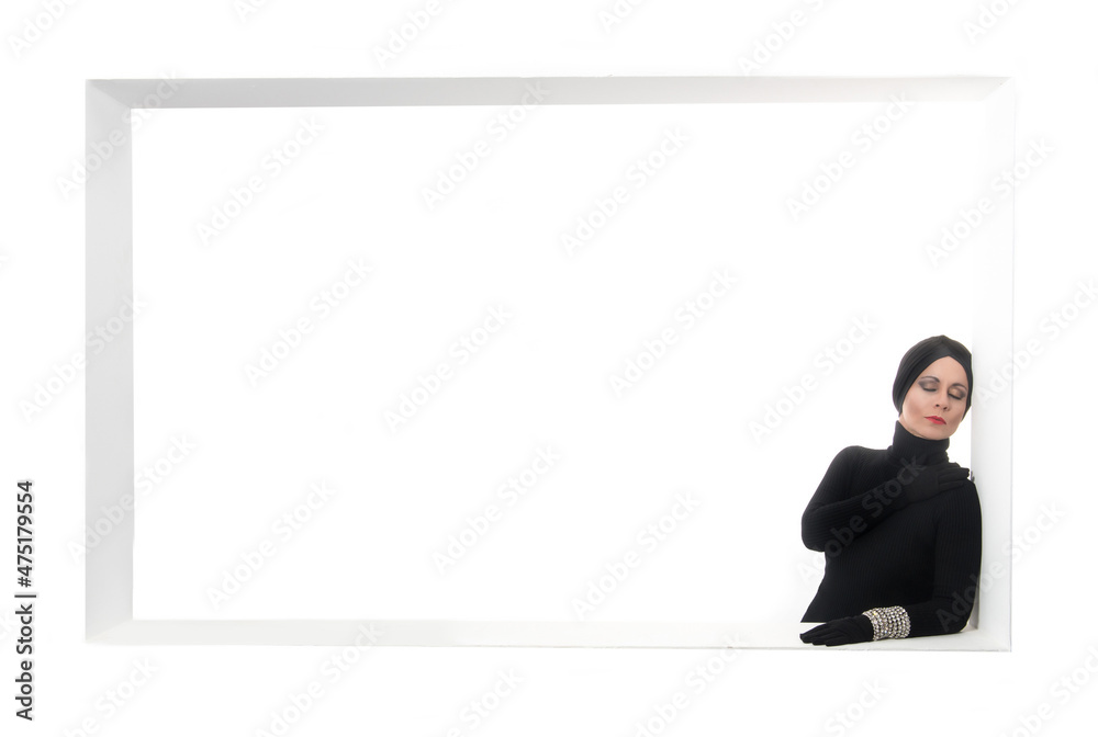 elegant woman made up and dressed in black with turban and gloves on a white background with copy space elegant woman made up and dressed in black with turban and gloves on a white background with copy space