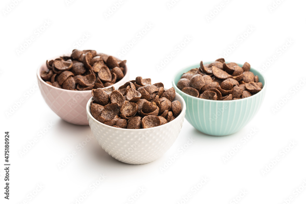 Sweet chocolate breakfast cereal flakes in bowl. Sweet chocolate breakfast cereal flakes in bowl.