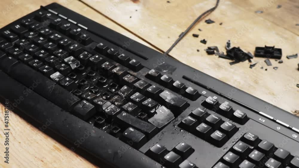Hammer hitting computer keyboard. Damage keyboard. Broken office