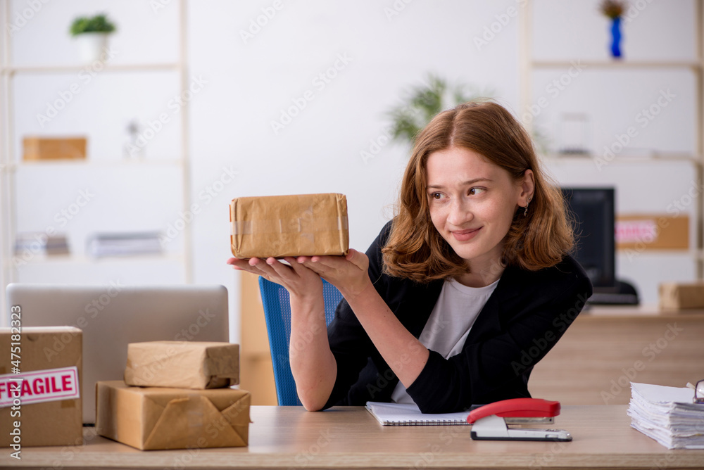 Young woman working in box delivery service