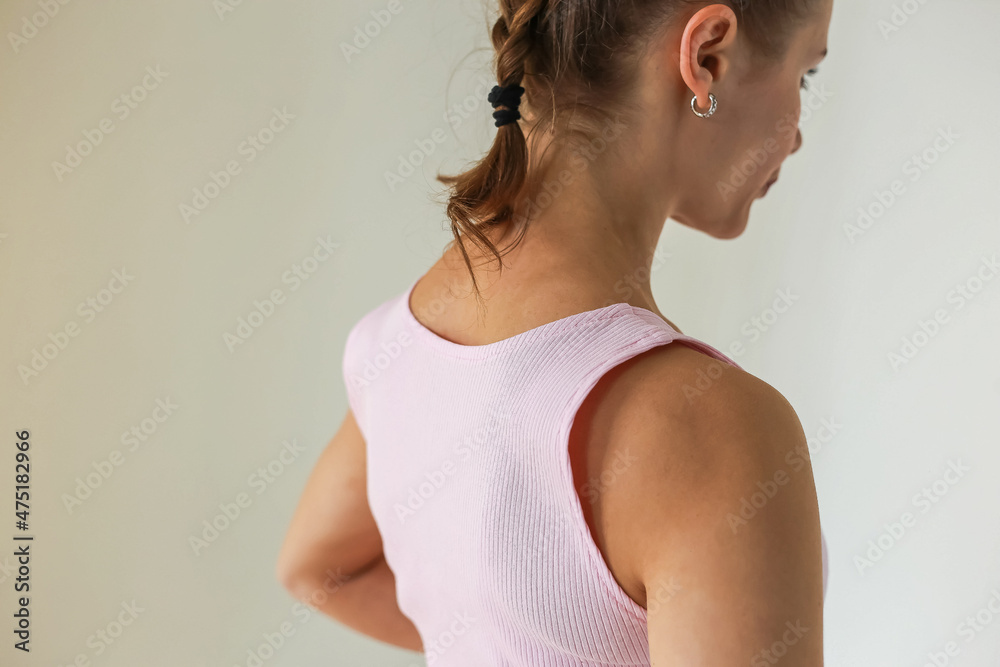 Girl in stylish, cozy sportswear against a bright background, studio shooting for a magazine, details of fabrics and flowers Girl in stylish, cozy sportswear against a bright background, studio shooting for a magazine, details of fabrics and flowers