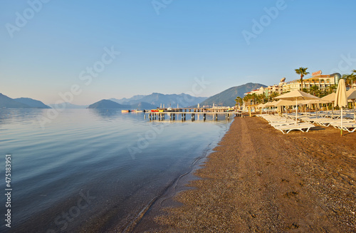 Deserted beach in the morning sun. The beach at dawn. Empty sunbeds. Beach without people. Marmaris photo