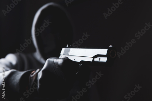 masked man holding a gun