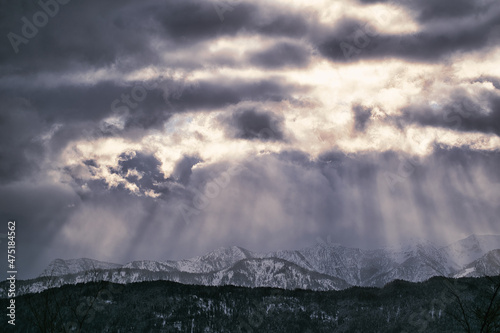 sun rays and clouds over the mountains