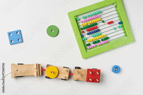 Math for kids. Various eco-friendly toy figures and bead counter for math photo