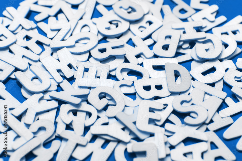 Heap of wooden latin alphabet letters number isolated on blue background. Stack decorated quote words text. Creative greering card title Heap of wooden latin alphabet letters number isolated on blue background. Stack decorated quote words text. Creative greering card title