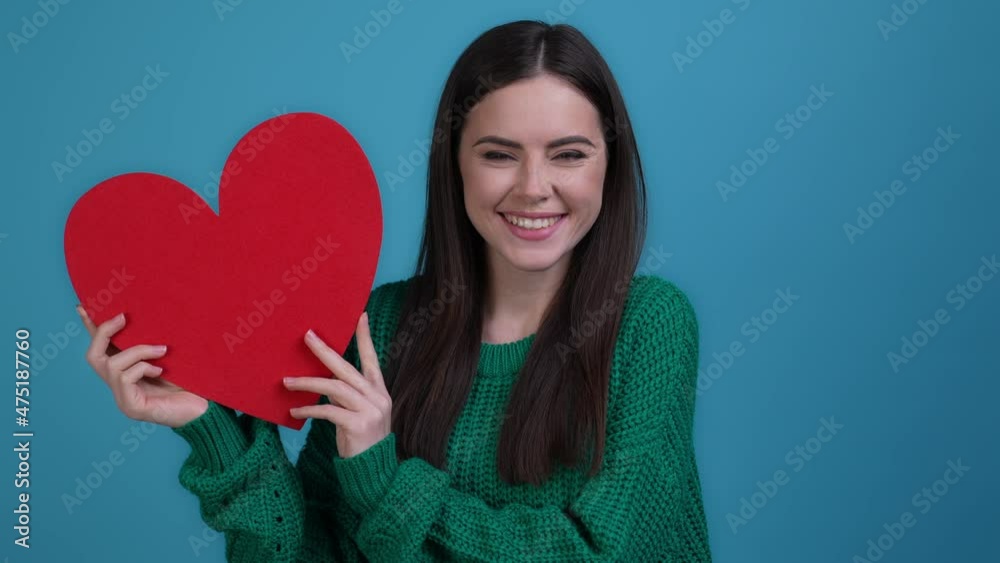 Charming lady show bid heart boyfriend gift isolated blue color background Charming lady show bid heart boyfriend gift isolated blue color background