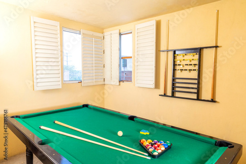 New pool table with balls and pool cues