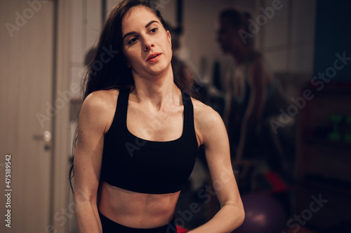 Portrait of a young woman in motion while training in the gym