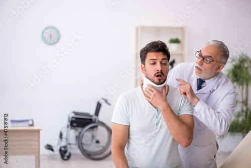 Young neck injured male patient visiting old male doctor