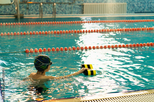 little boy swimming in the pool, the concept of children's sports