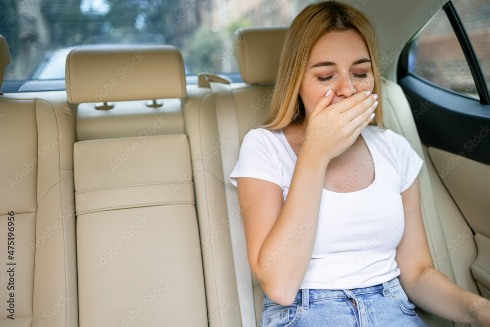 Woman suffering from motion sickness in a car - obrazy, fototapety, plakaty 