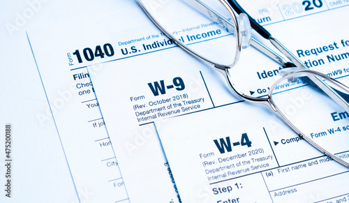 Financial Image Of Some Tax Forms With Glasses And A Pen