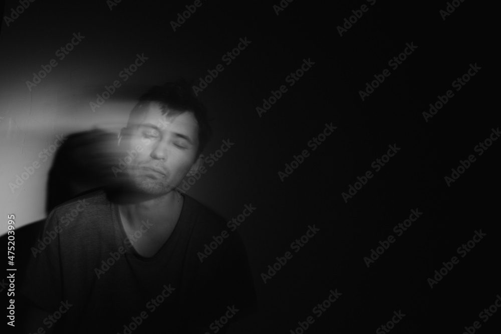 Blurred male portrait in the dark. Male portrait in motion in the dark. Blurred male portrait in the dark. Male portrait in motion in the dark.