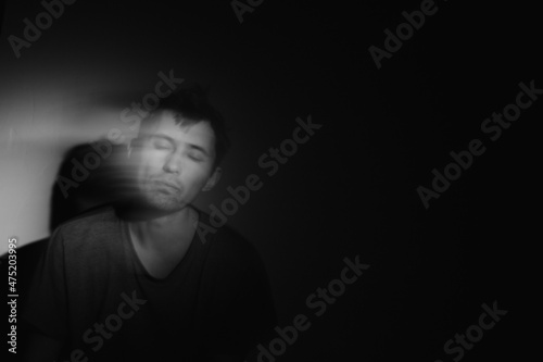 Blurred male portrait in the dark. Male portrait in motion in the dark. 
