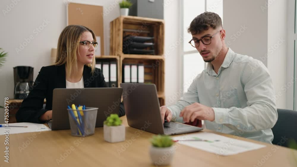 Young couple business workers using laptop working at office Young couple business workers using laptop working at office