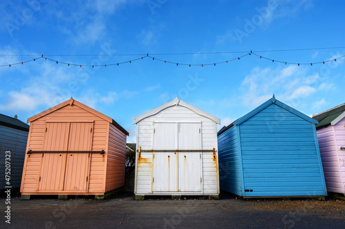 Three beach huts. These colorful beach huts are on the promenade in Felixstowe, Suffolk, UK an English resort town.