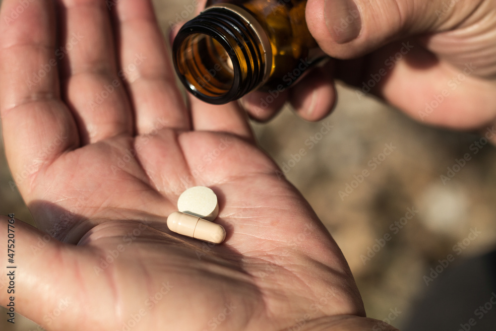 Photo of a senior woman hand holding a pills Photo of a senior woman hand holding a pills