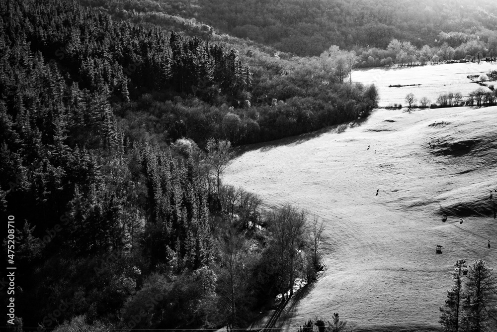 Valley landscape with river in black and white.