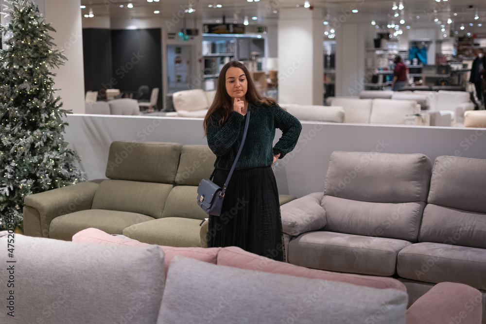Woman choosing sofa in mall Woman choosing sofa in mall