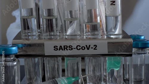 SARS COV 2 Test Tubes Labelled Alpha Gamma Delta Beta And Omicron Variants In Rack. Slow Pan Up photo