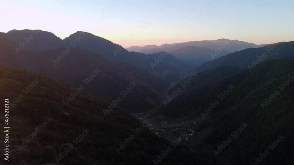 Flying low over the trees on the top of a hill into the valley beyond in the morning light of the sun. Flying low over the trees on the top of a hill into the valley beyond in the morning light of the sun.