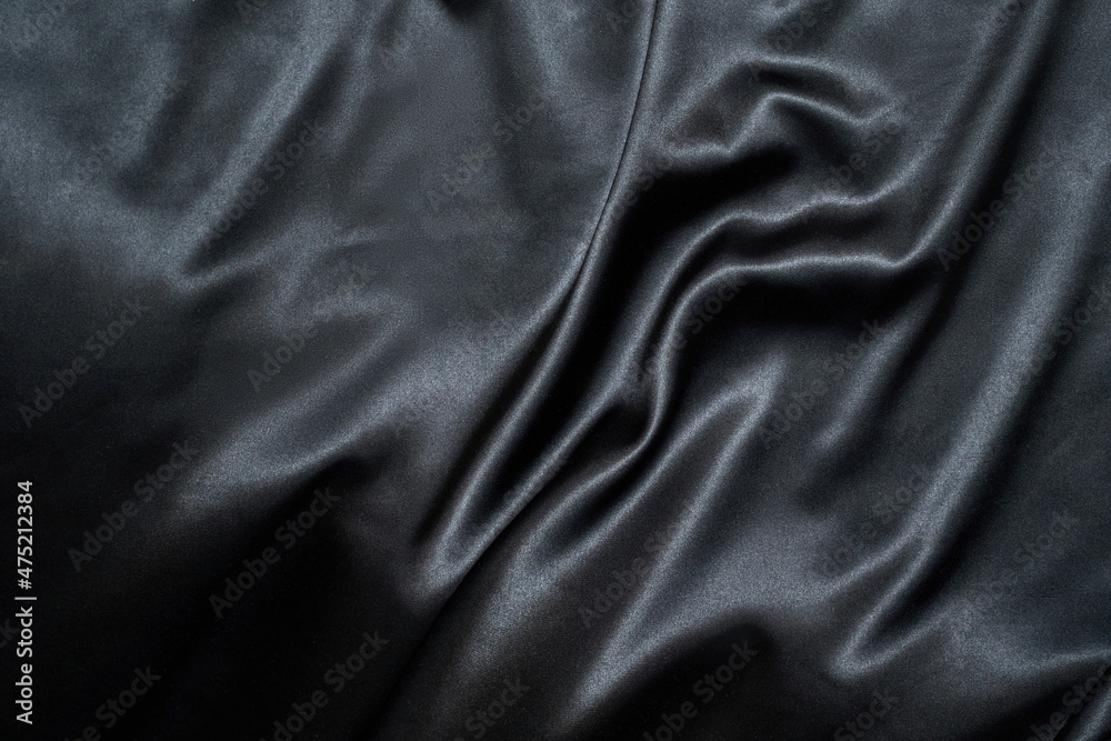 Fototapeta premium Black wavy silk background. Satin fabric texture. Dark elegant rich backdrop. Delicate design. Shine decoration christmas material. Tender art drape. Beautiful romantic textile