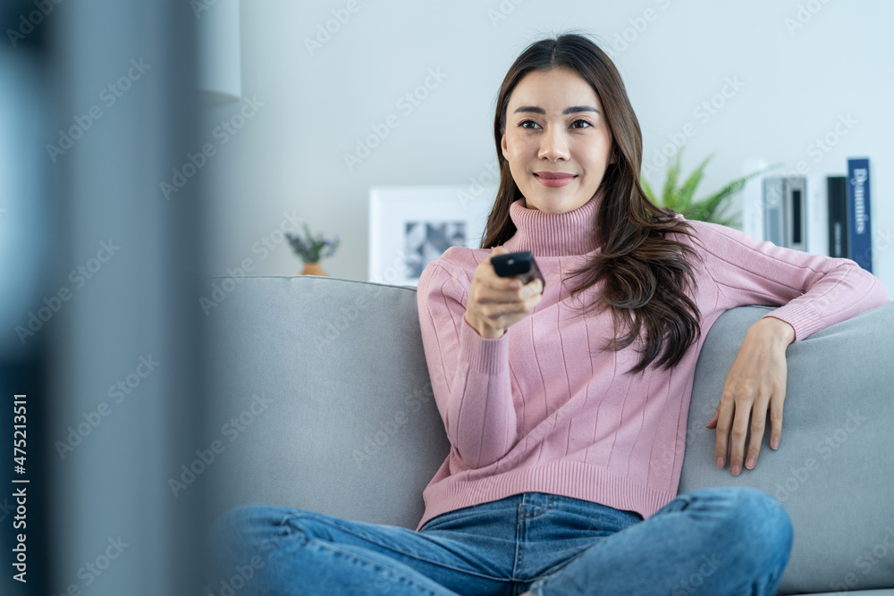 Asian young beautiful woman watching fun movie on television at home. Asian young beautiful woman watching fun movie on television at home.