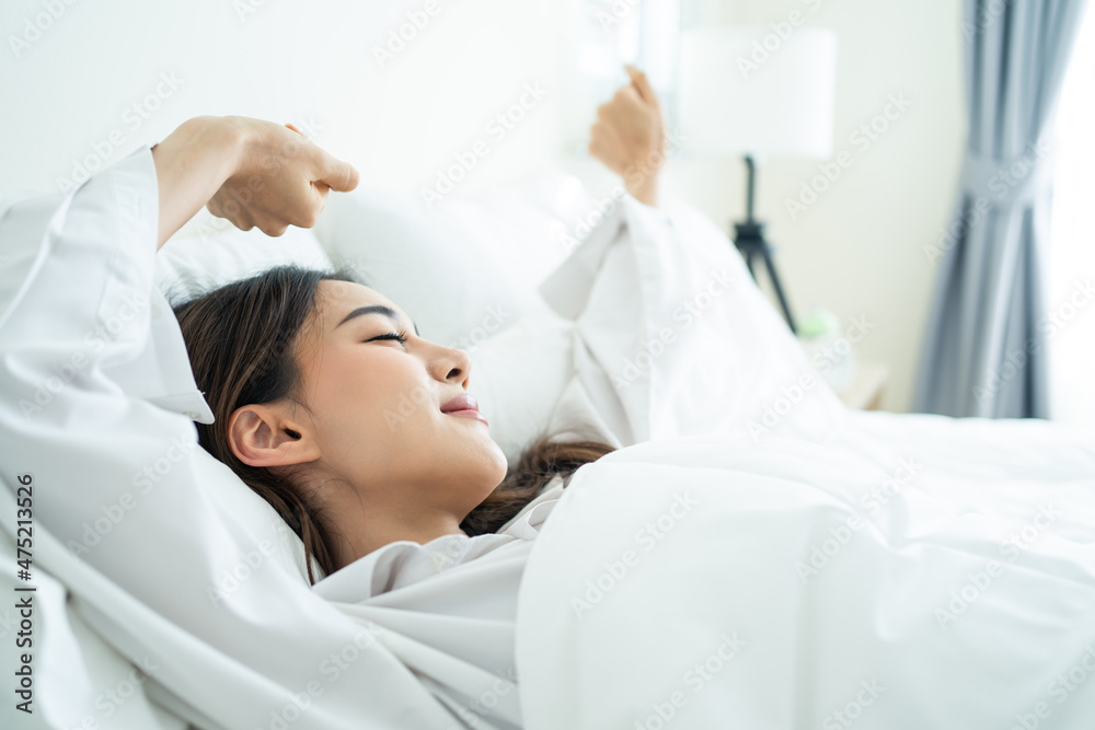 Asian beautiful girl in pajamas wake up in the morning with happiness. Asian beautiful girl in pajamas wake up in the morning with happiness.