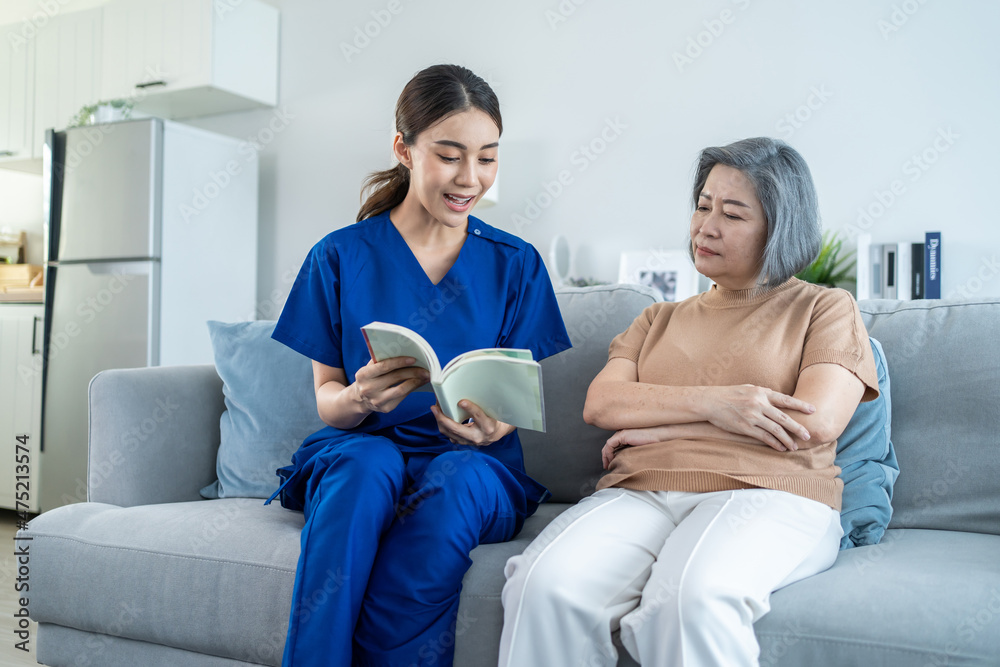 Asian woman nurse taking care of senior elderly female at nursing home Asian woman nurse taking care of senior elderly female at nursing home