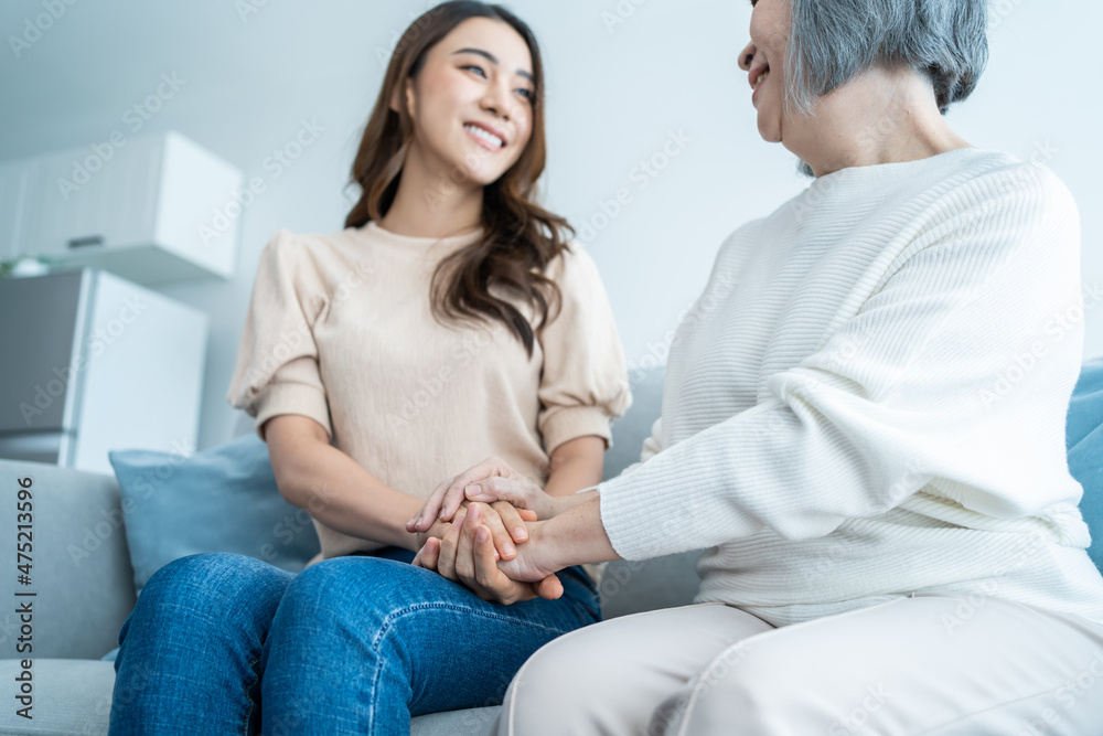 Asian lovely family, young daughter hugging and sit with older mother. Asian lovely family, young daughter hugging and sit with older mother.