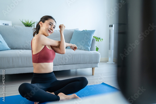 Asian young beautiful active woman doing Yoga Pilates workout at home.