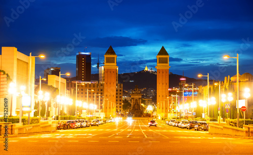 Picturesque Barcelona cityscape in summer twilight overlooking lighted avenue Avinguda de la Reina Maria Cristina with two Venetian Towers at junction with Placa dEspanya, Spain. photo